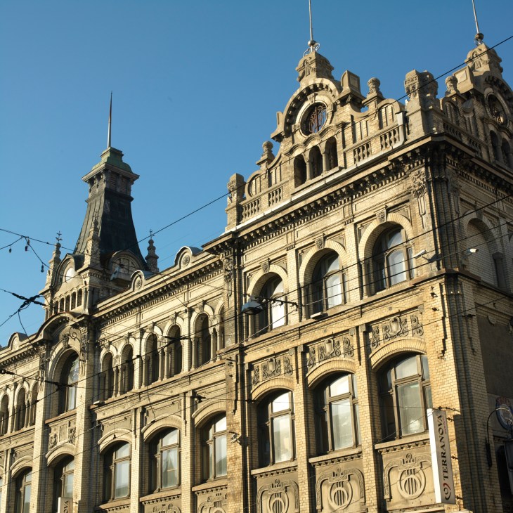 Ornate pre-revolutionary 19th-century building facade in Vladivostok with decorative towers and arched windows.