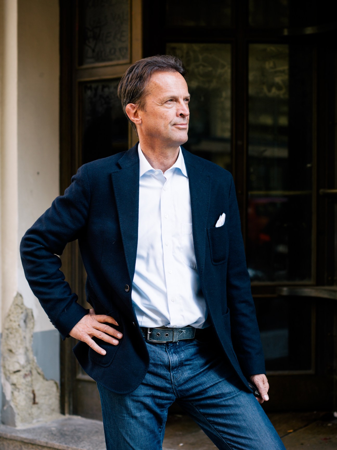 Hermann Kaufmann, CEO of Otrans art shipping company, stands outside a building in a navy blazer and white shirt.