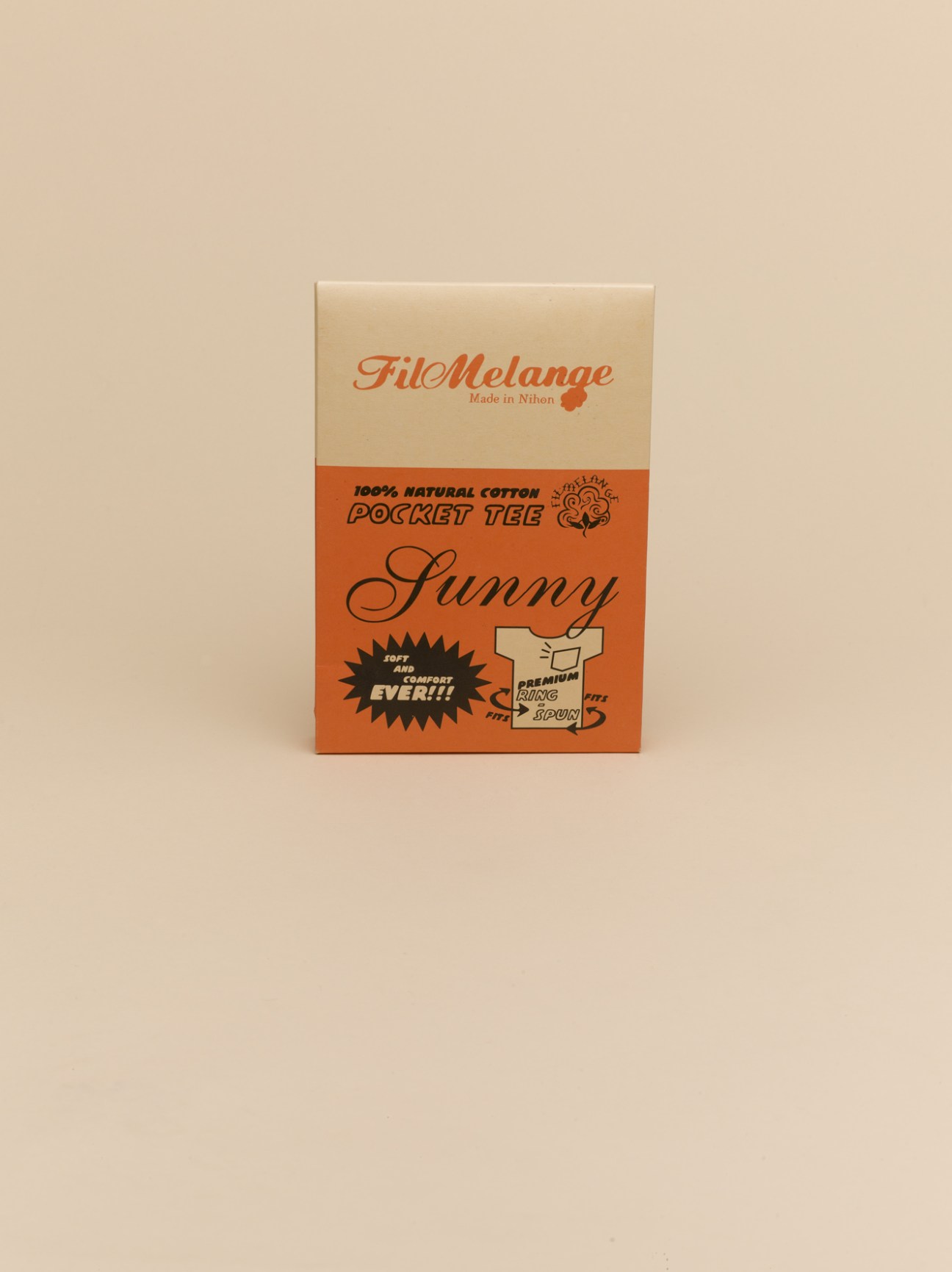 FilMelange Pocket Tee packaging box with retro design and orange graphics on cream background.