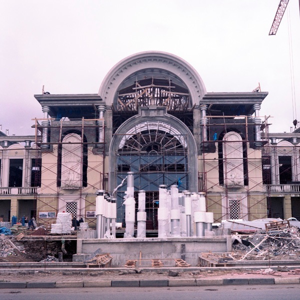 The New Batumi Ballet and Opera Theatre under construction with classical architecture featuring arched windows and columns.