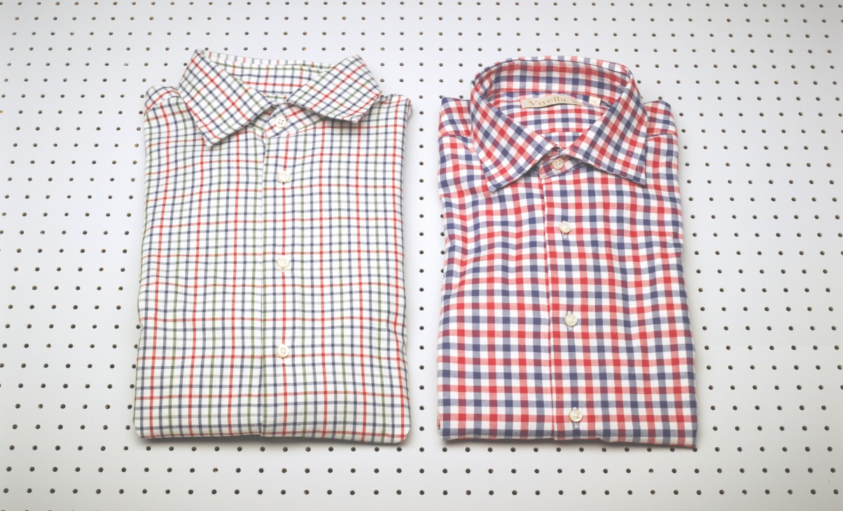 Two folded checkered cotton-cashmere blend shirts in red, white and navy patterns from Viyella 1784.