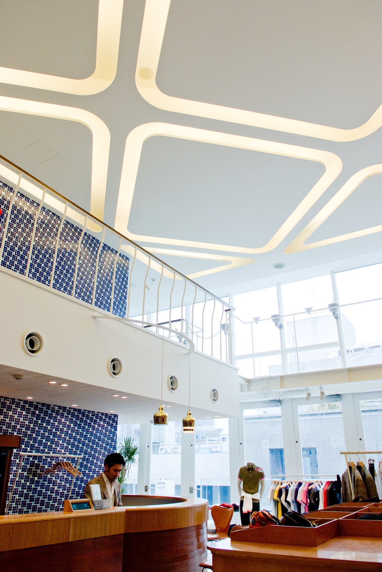 Interior of Beams Fukuoka store with modern ceiling, blue tile wall, and clothing displays.