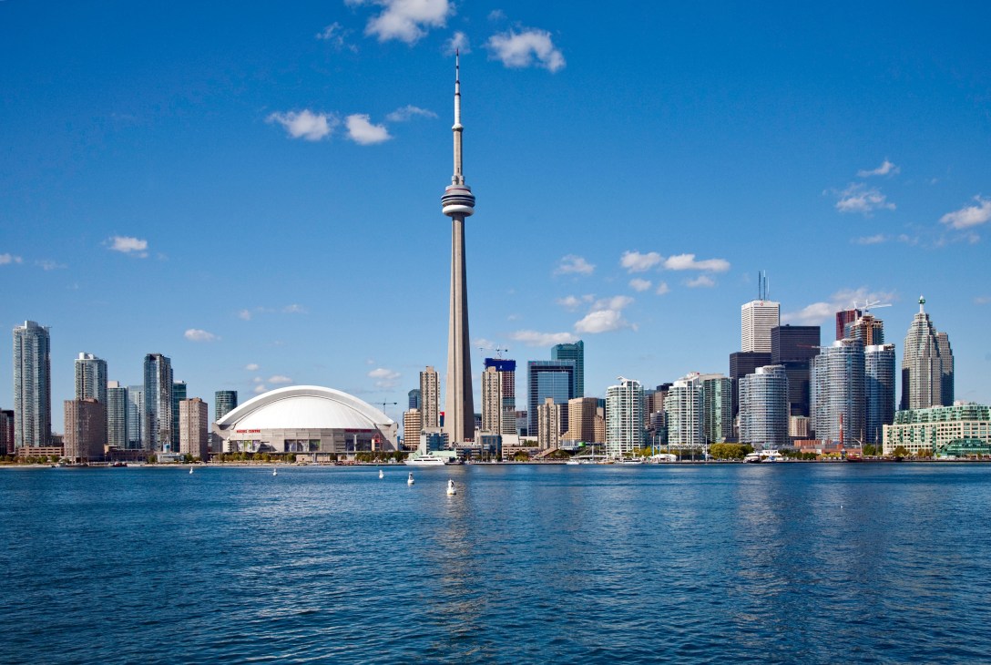 Toronto skyline featuring CN Tower and downtown skyscrapers viewed across Lake Ontario on a clear day