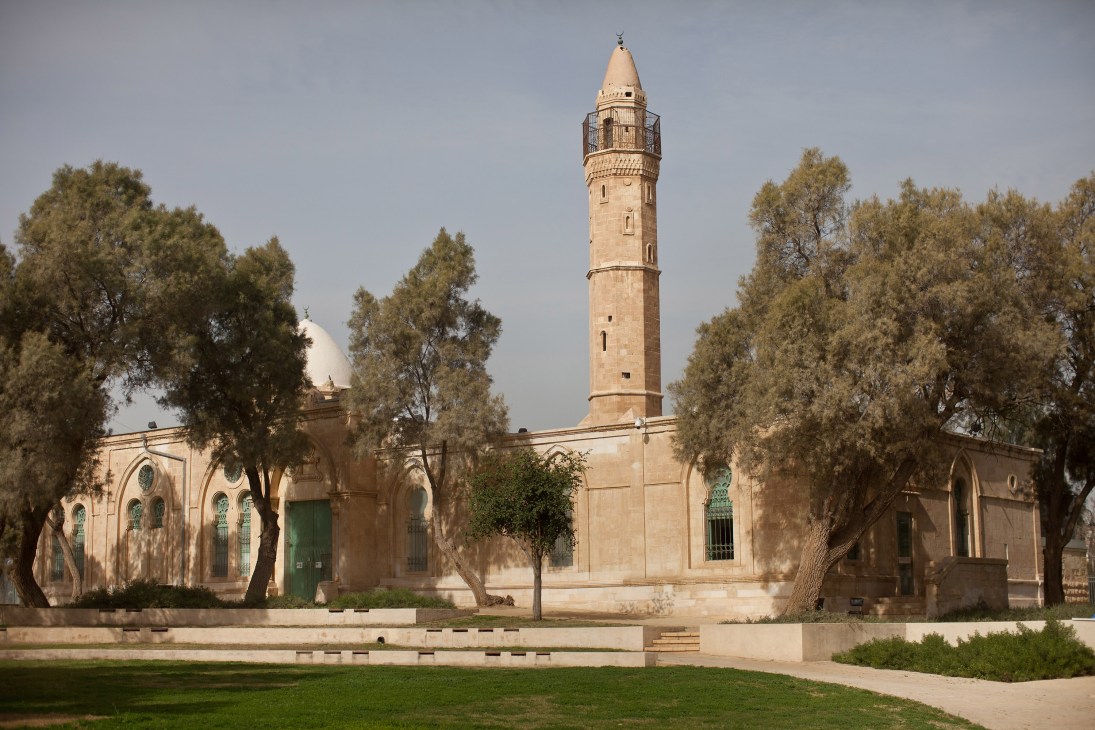 Ottoman mosque with tall minaret surrounded by olive trees, now serving as an Islamic art gallery in Be'er-Sheva.