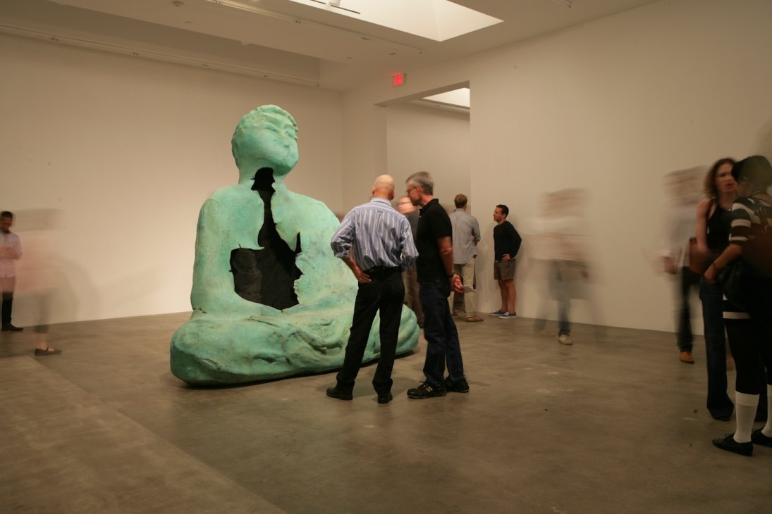 Visitors viewing a large turquoise sculpture titled Hiroshima Buddha by Matt Johnson at Blum & Poe gallery.