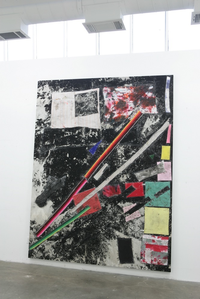 A large abstract artwork by Sterling Ruby featuring black and white textured surfaces with colorful geometric shapes and a red pencil.