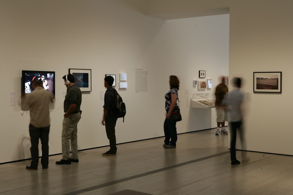 Gallery visitors viewing artworks displayed on white walls at LACMA.