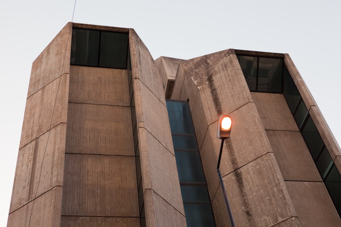 Modern brutalist building with angular copper-colored facade and rectangular windows on rue de Rome in Beirut.