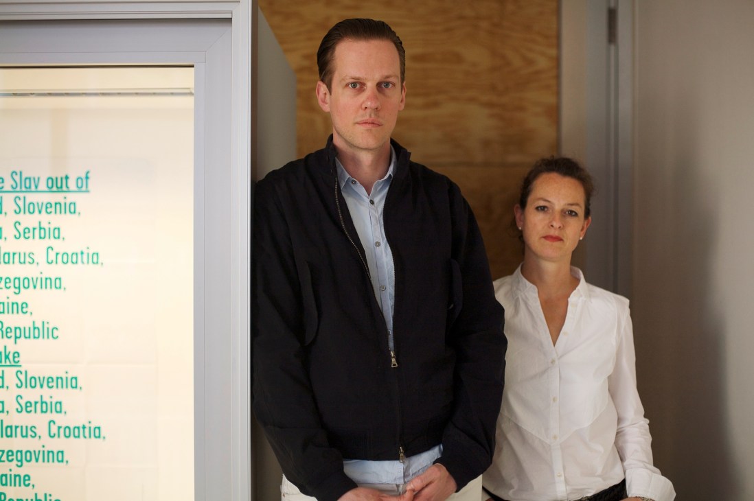 Jörg Koch and Sandra von Mayer-Myrtenhain, publishers of fashion magazine 032c, stand in a gallery space.