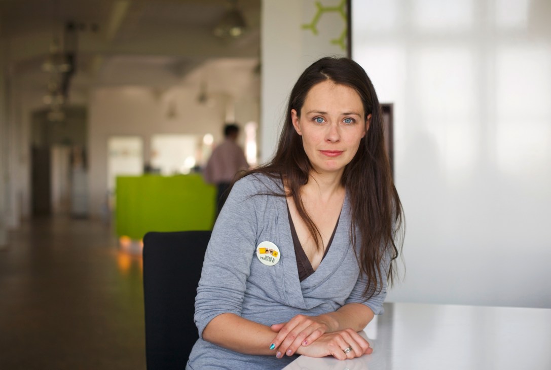 Nicole Srock-Stanley, managing director of architects dan pearlman, sits at a desk in a modern office