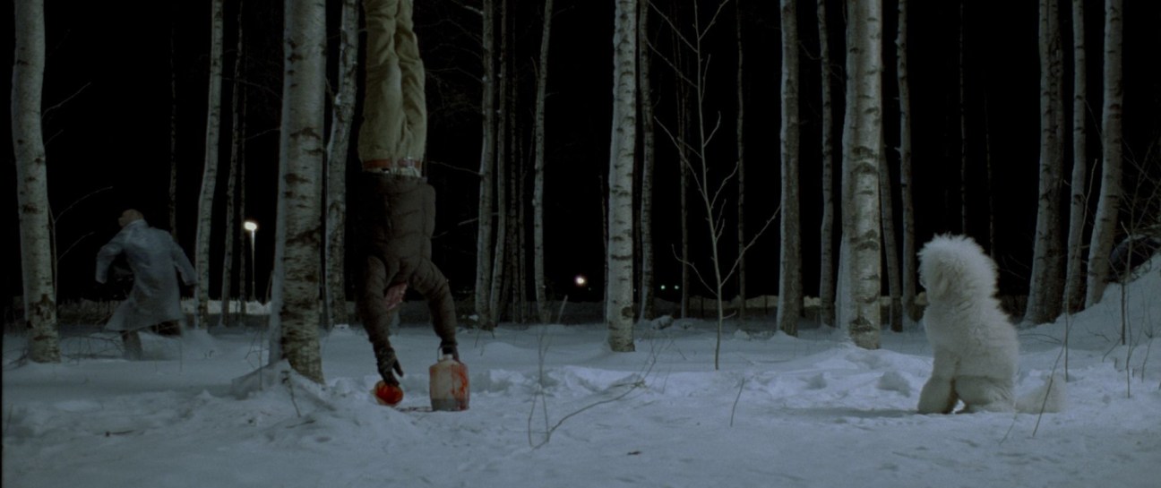 Snowy forest scene at night with figures and a pale child in winter landscape from Let the Right One In.