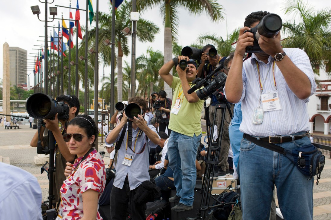 Photographers and videographers with cameras and equipment covering the arrival of heads of state at the Summit of the Americas in Cartagena.