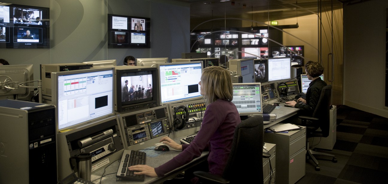 BBC Persian TV editing suite with staff monitoring multiple screens and broadcast equipment.