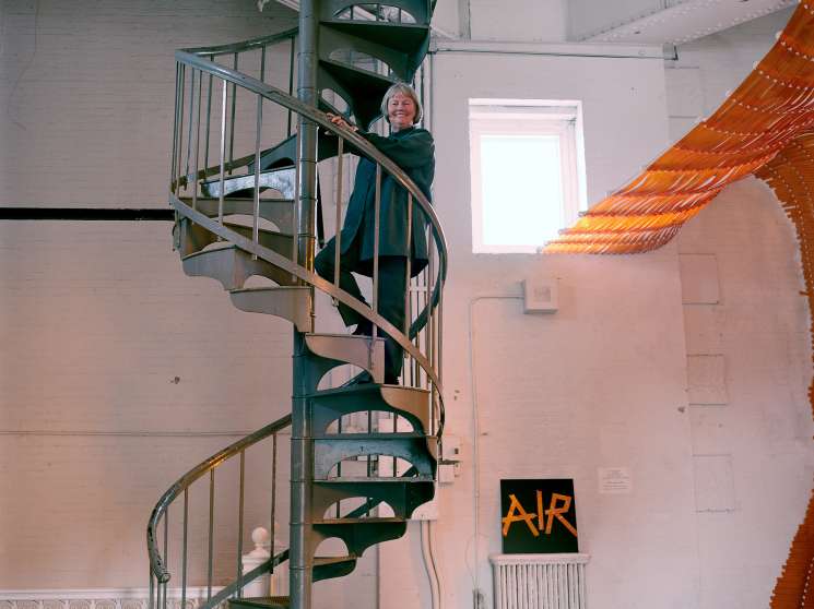 Alanna Heiss stands on a spiral staircase inside the Clocktower Gallery in lower Manhattan.