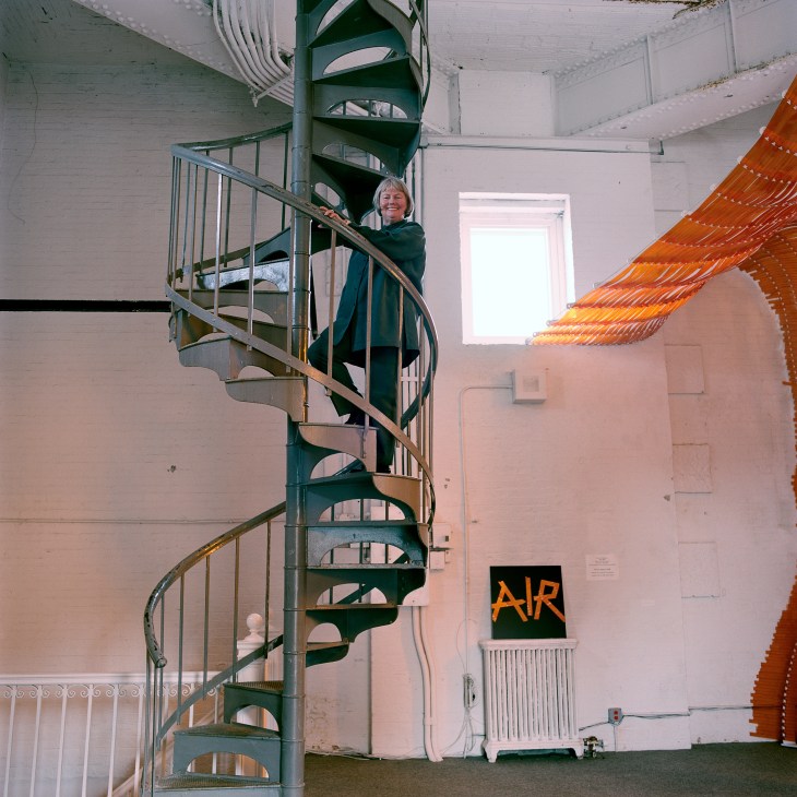 Alanna Heiss stands on a spiral staircase inside the Clocktower Gallery in lower Manhattan.