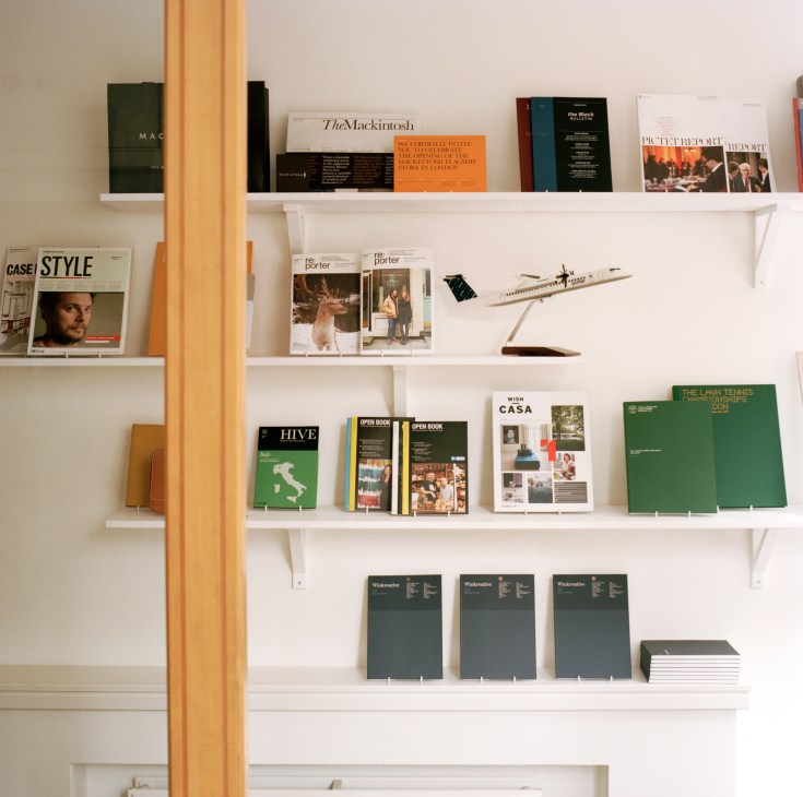 White shelving displaying Monocle and Winkreative publications, design objects, and project work samples.