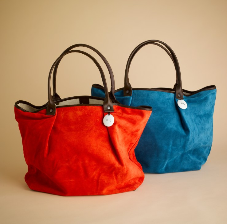 Two colorful velvet totes with leather handles in red and blue shades by Manufacture des Rigoles.