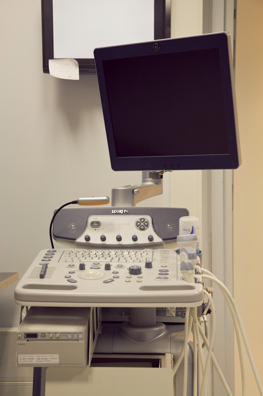 Oncos ultrasound machine with control panel and monitor displaying medical imaging equipment.