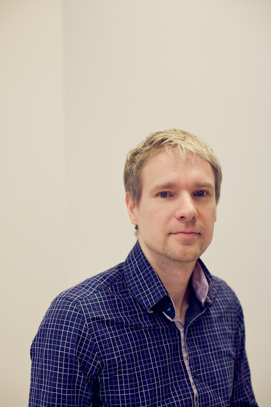 Harri Holopainen, CEO of Microtask, wearing a blue checked shirt against a neutral background.