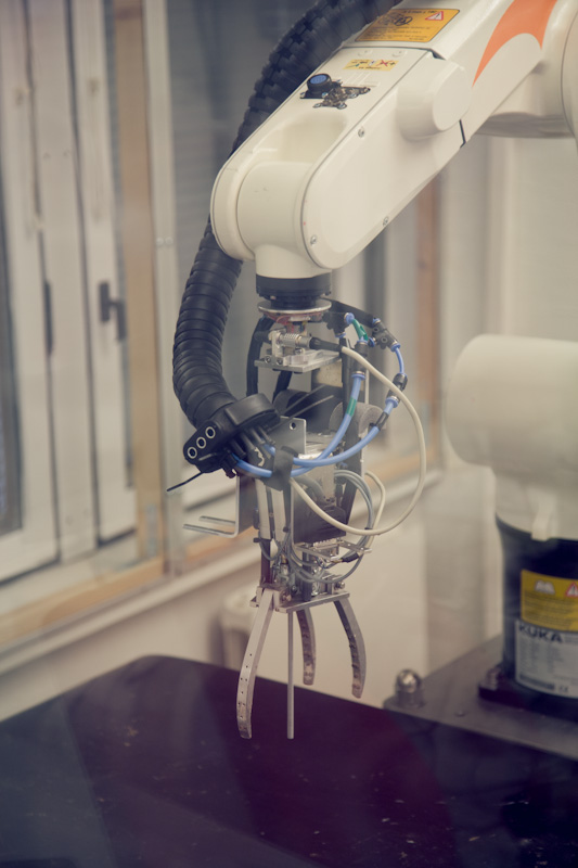 Close-up of ZenRobotics intelligent robotic arm with gripper mechanism and sensors in operation.