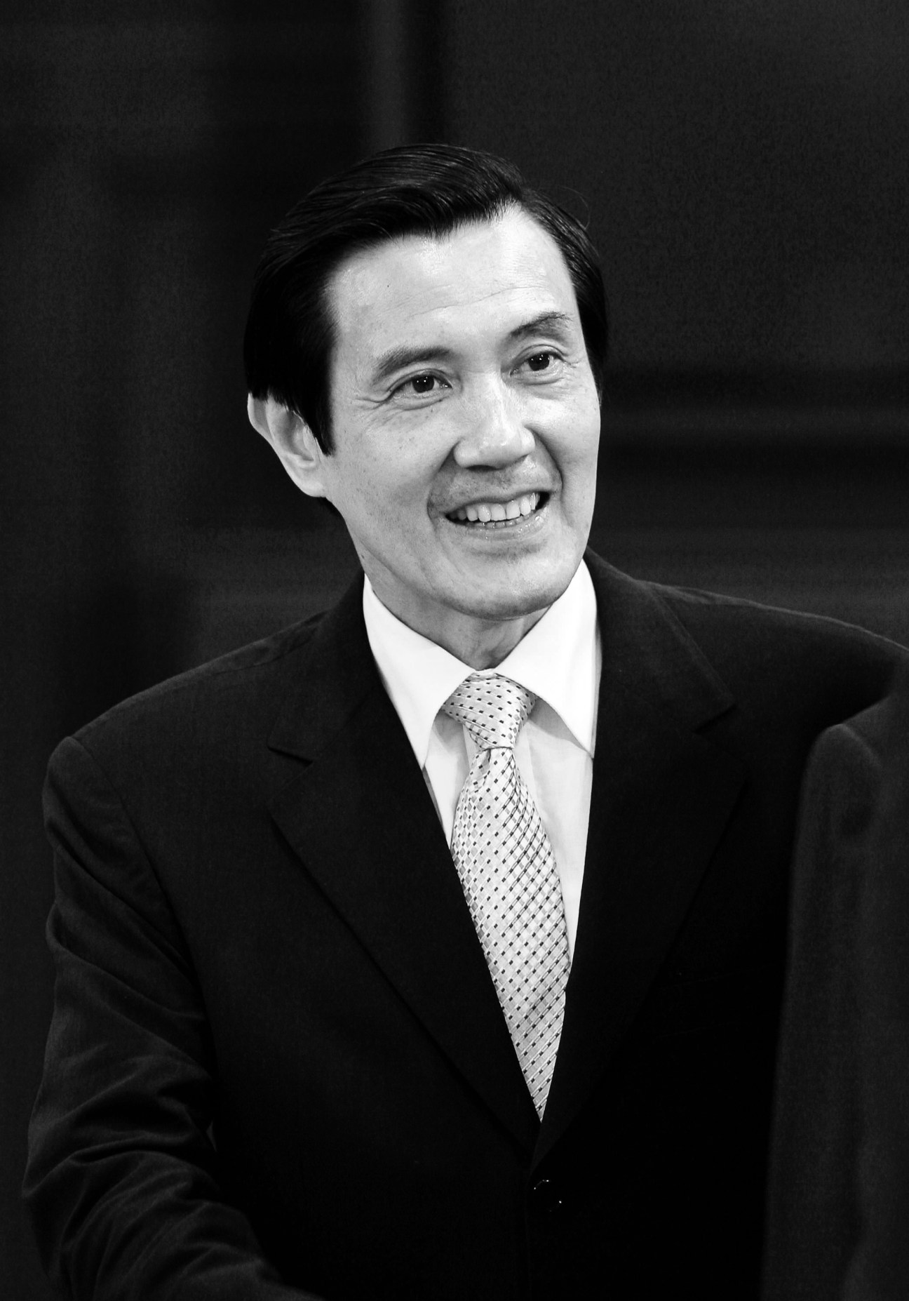Black and white portrait of Ma Ying-jeou, Taiwan's president, in a dark suit and patterned tie.