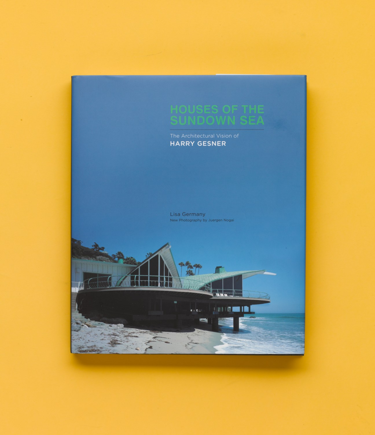 Book cover for 'Houses of the Sundown Sea' featuring Harry Gesner's architectural work on a yellow background.