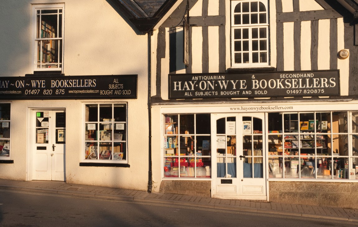 Hay-on-Wye antiquarian booksellers storefront with half-timbered architecture and large display windows filled with books.