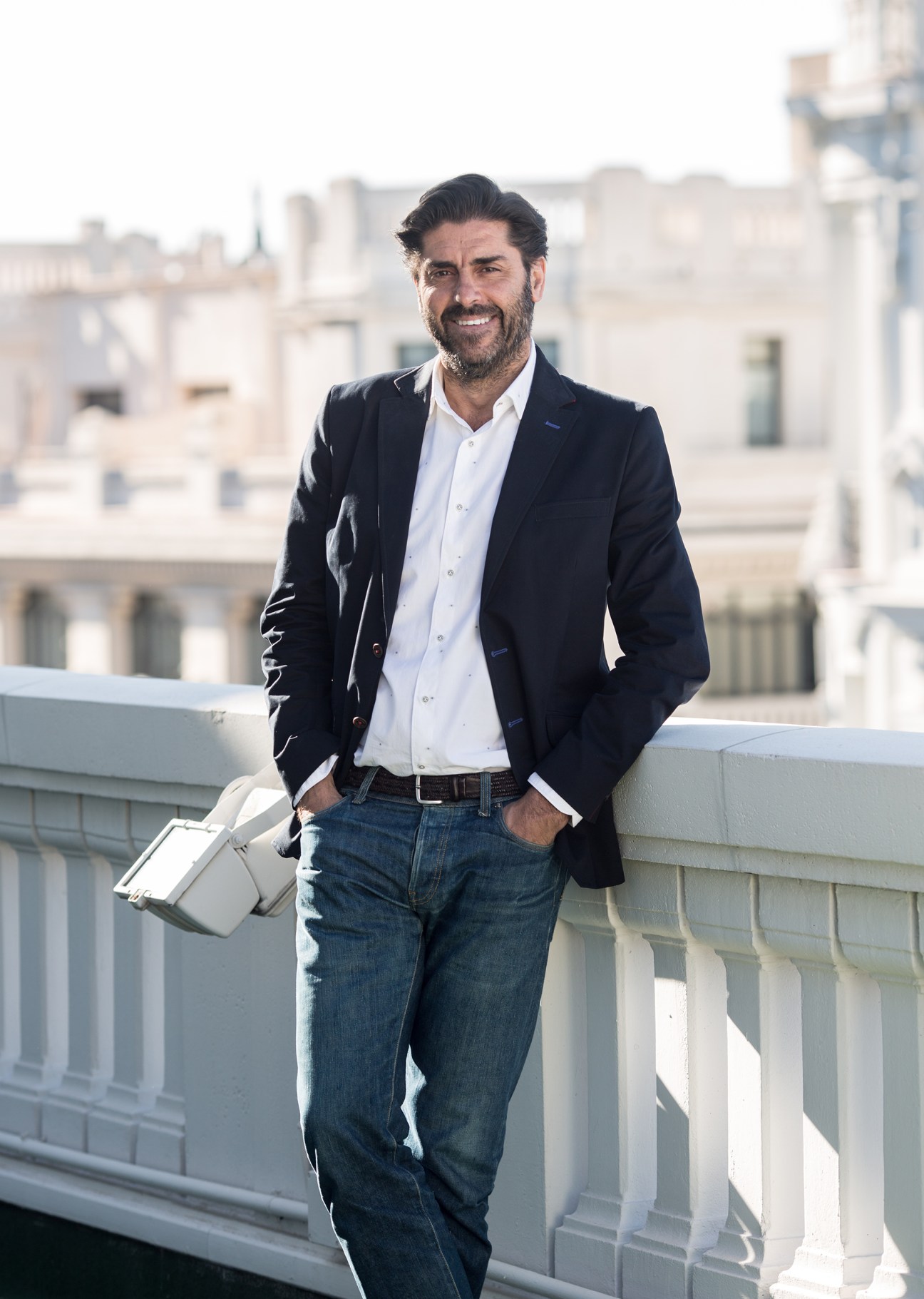 Vincente Jiménez, Cadena SER director, standing on a rooftop terrace overlooking Madrid's cityscape.