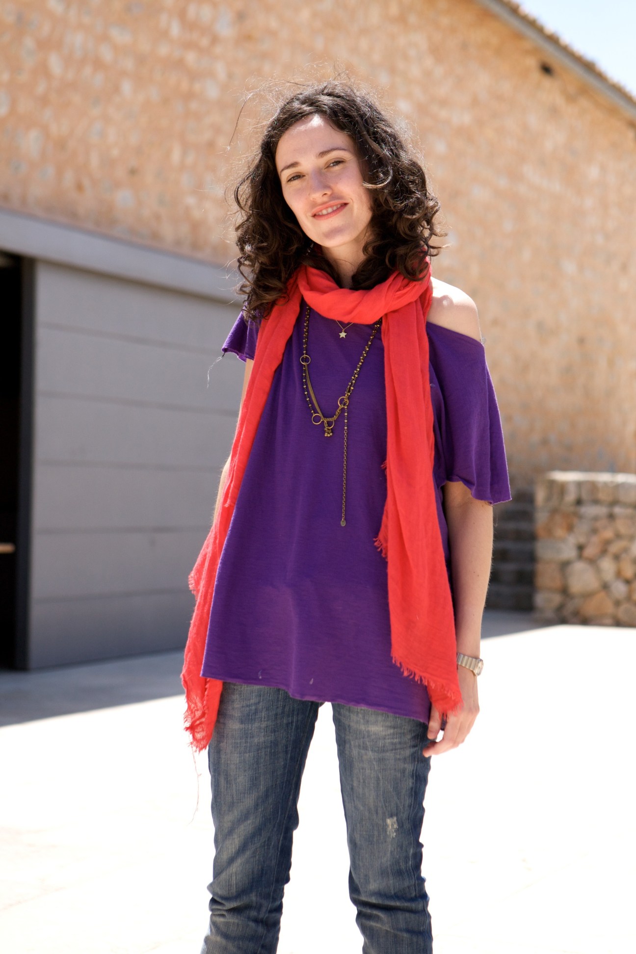Student Miren Mancisidor stands outdoors wearing a purple top and red scarf.