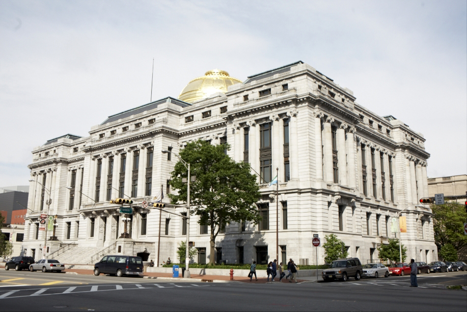 Newark's City Hall, a grand neoclassical building with white stone facade, columns, and gold dome.