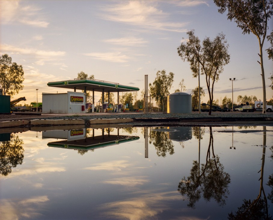 Capricorn roadhouse reflected in standing water after rainfall in Western Australia's outback.