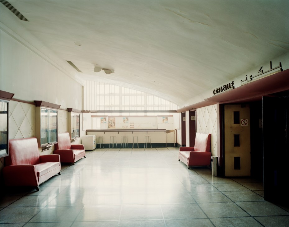 Interior of Cinema Lutetia, a vintage Art Deco cinema with red and cream seating, polished floor, and geometric architectural details.