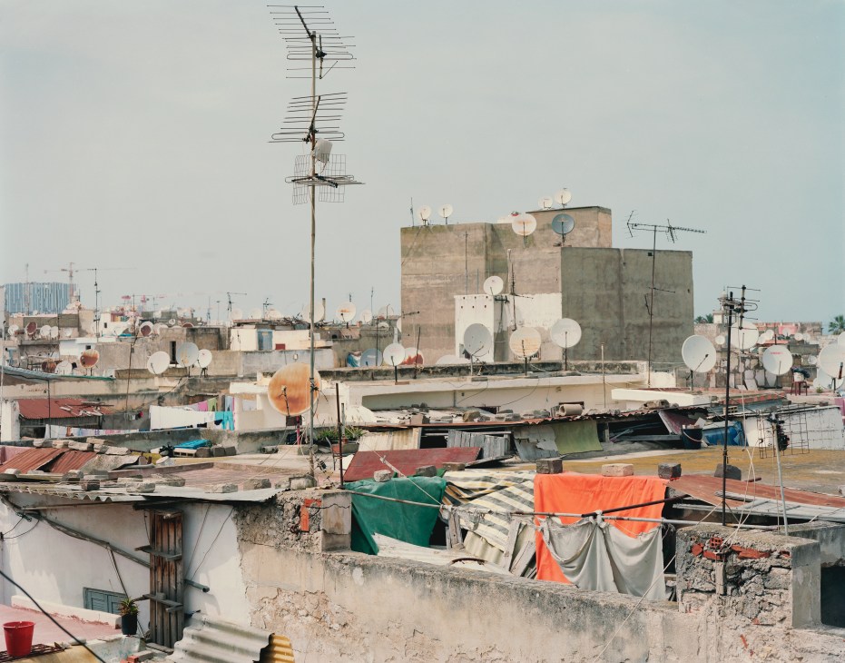 Rooftop view of Casablanca's Old Medina showing weathered buildings with satellite dishes and clotheslines.