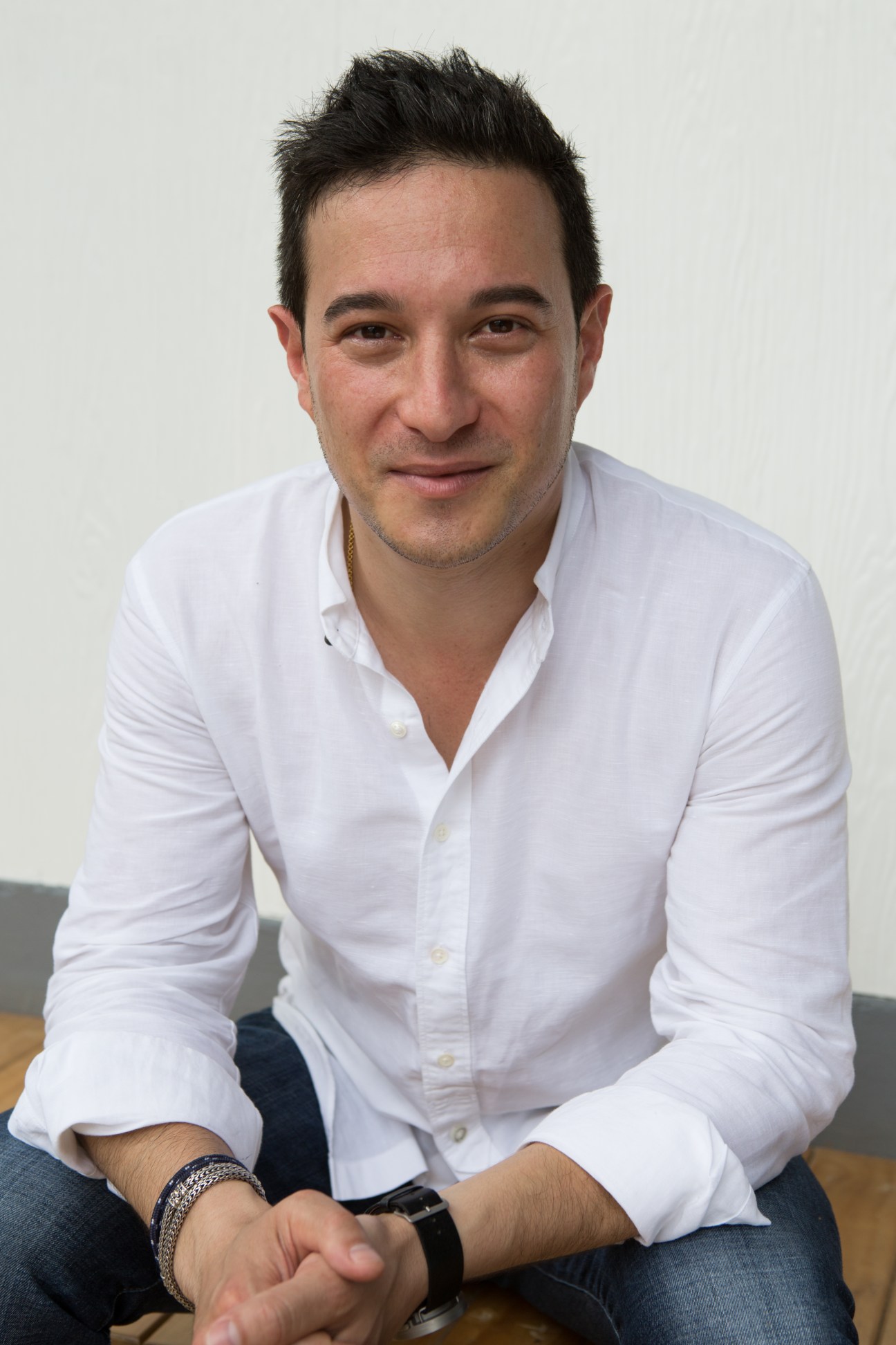 Portrait of Jay Spencer, co-founder of The Barkyard Bangkok, wearing a white shirt.