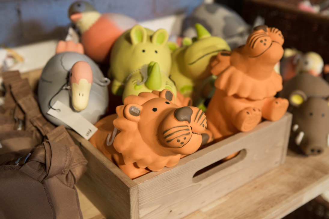 Colorful dog toys displayed in a wooden box at the Fetch shop.