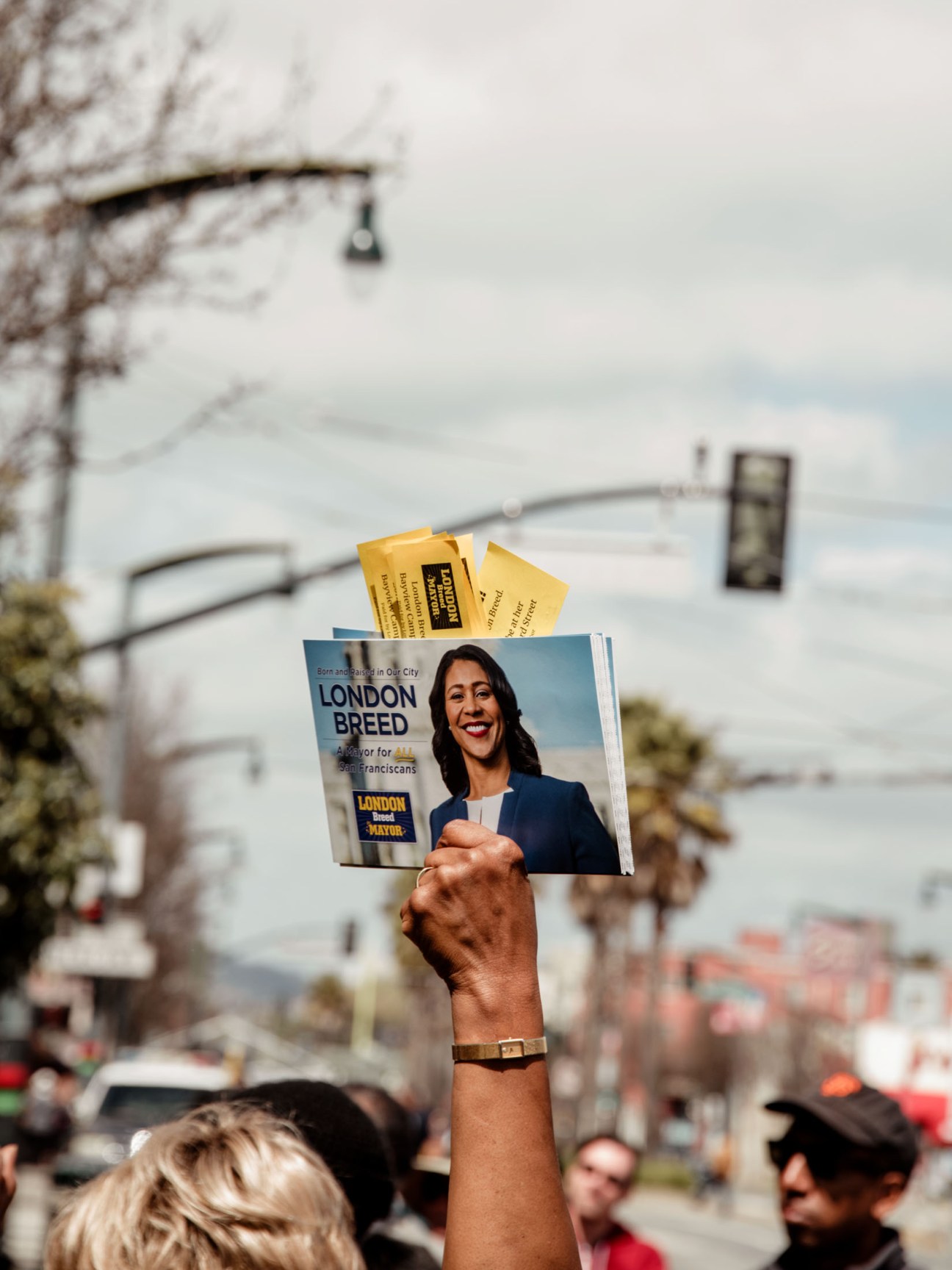 A person's hand holds a London Breed campaign ballot at a San Francisco polling location.