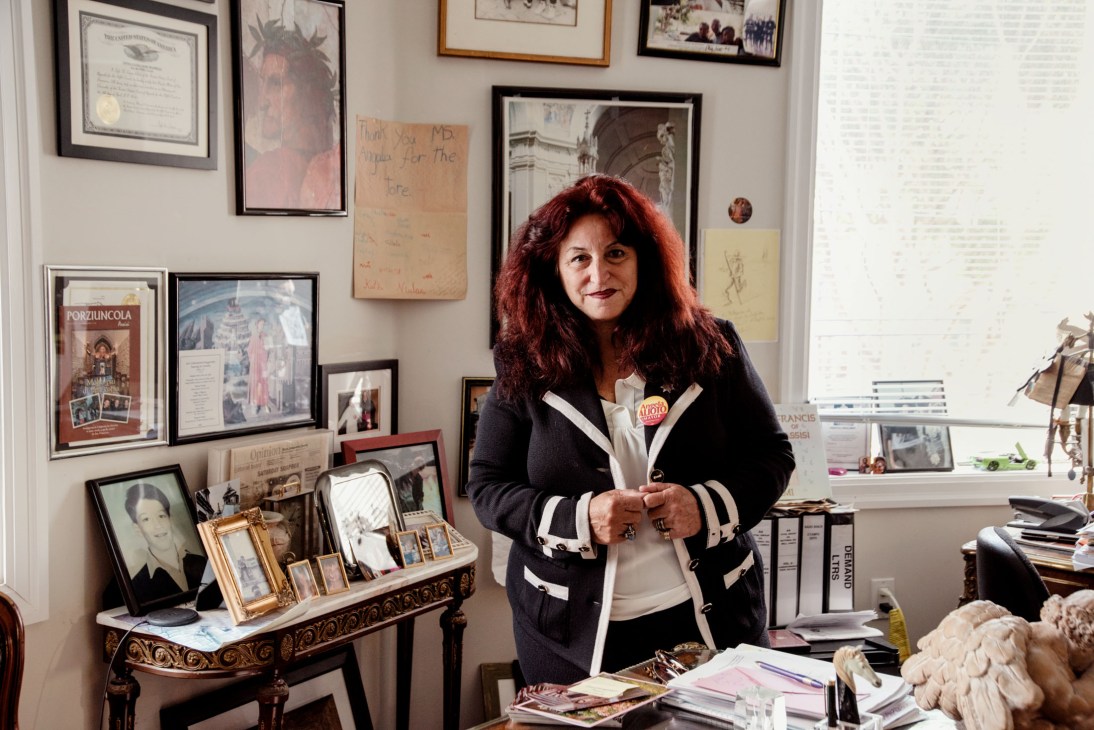 Angela Alioto stands in her law office surrounded by framed photographs, certificates, and memorabilia from decades of political service.