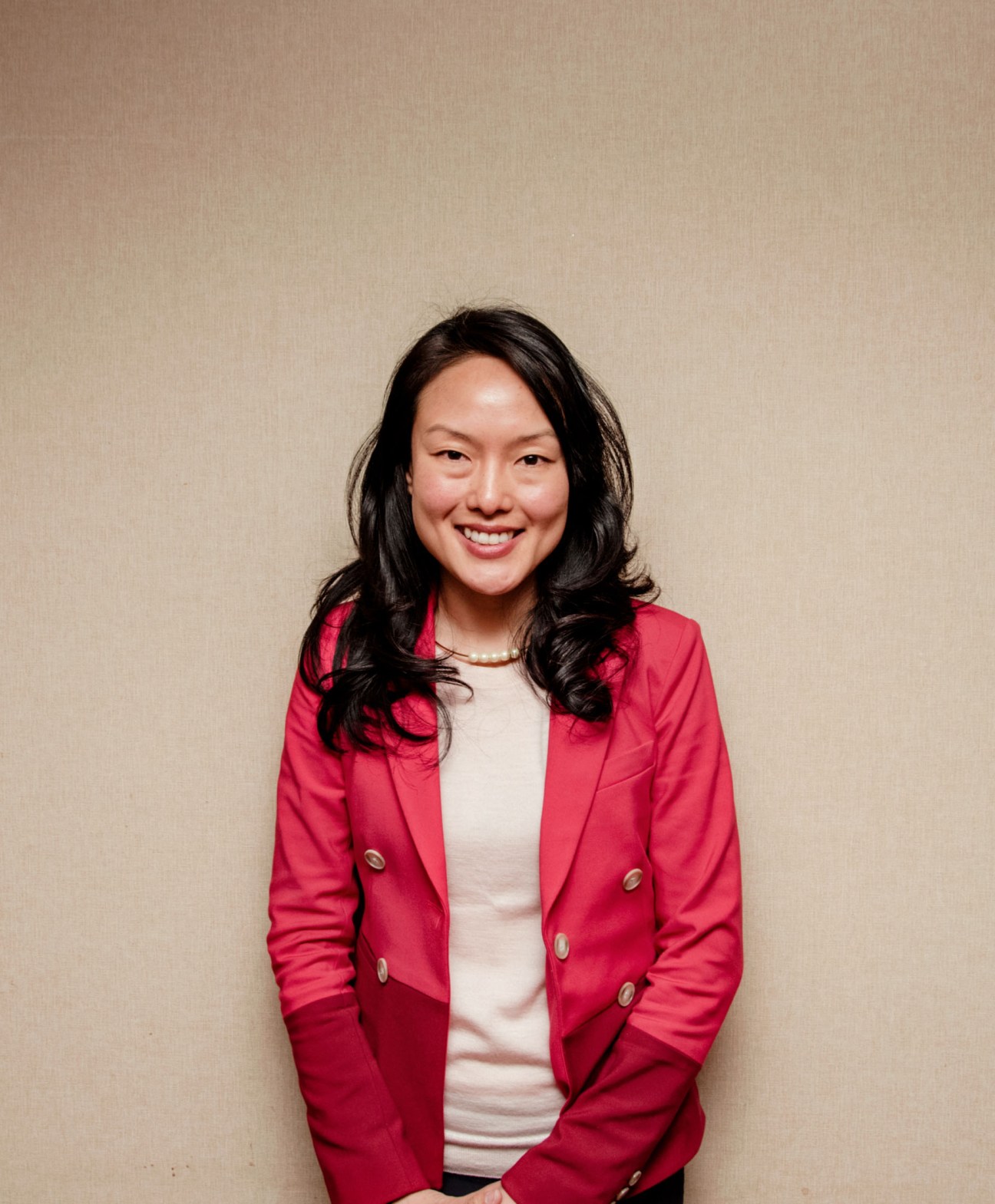 City supervisor Jane Kim in a red blazer and white top smiling against a neutral background.