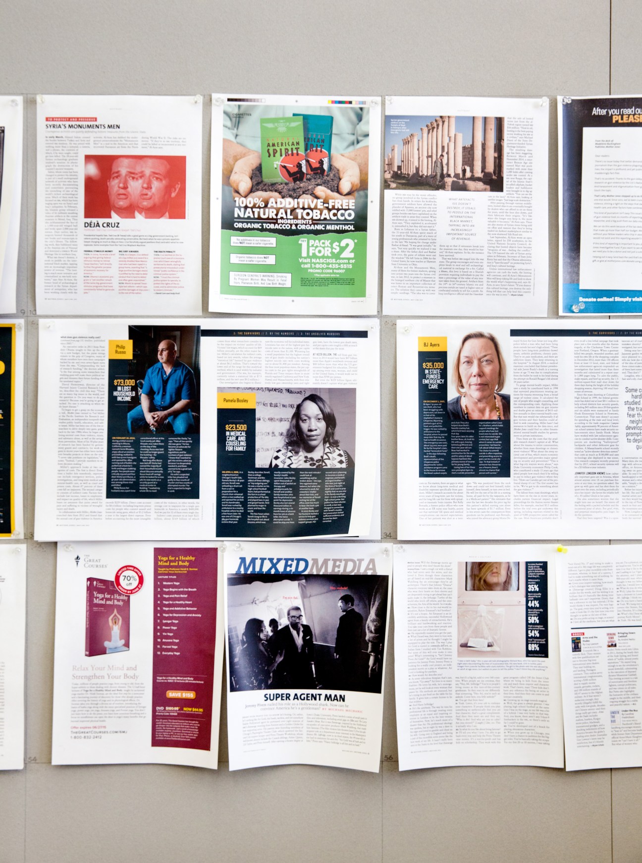 Magazine pages and features laid out for review at Mother Jones office.
