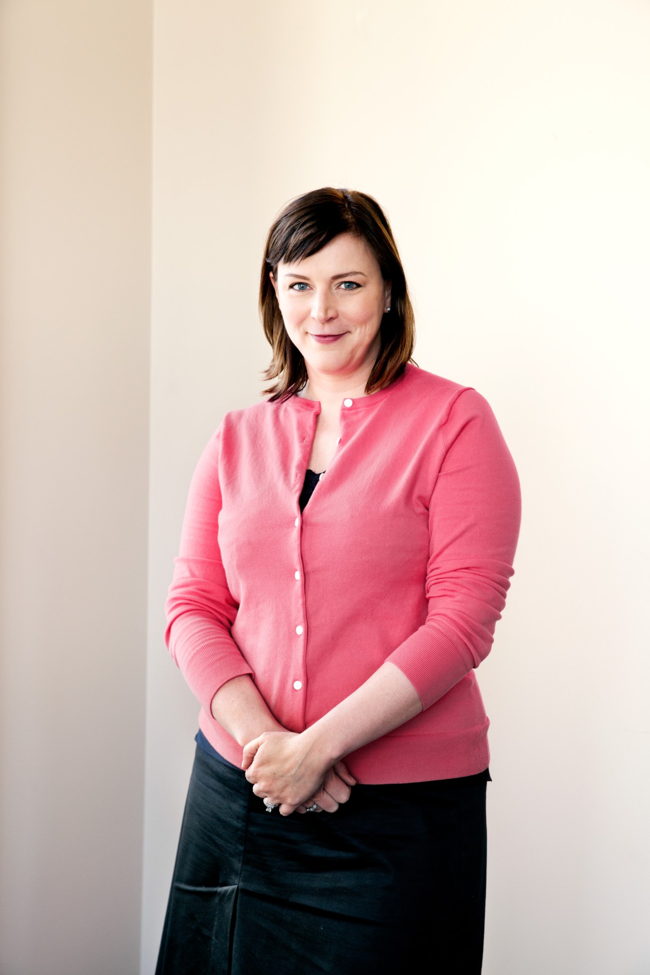 Audrey Cooper, editor in chief of the San Francisco Chronicle, wearing a pink cardigan and dark skirt in a professional portrait.