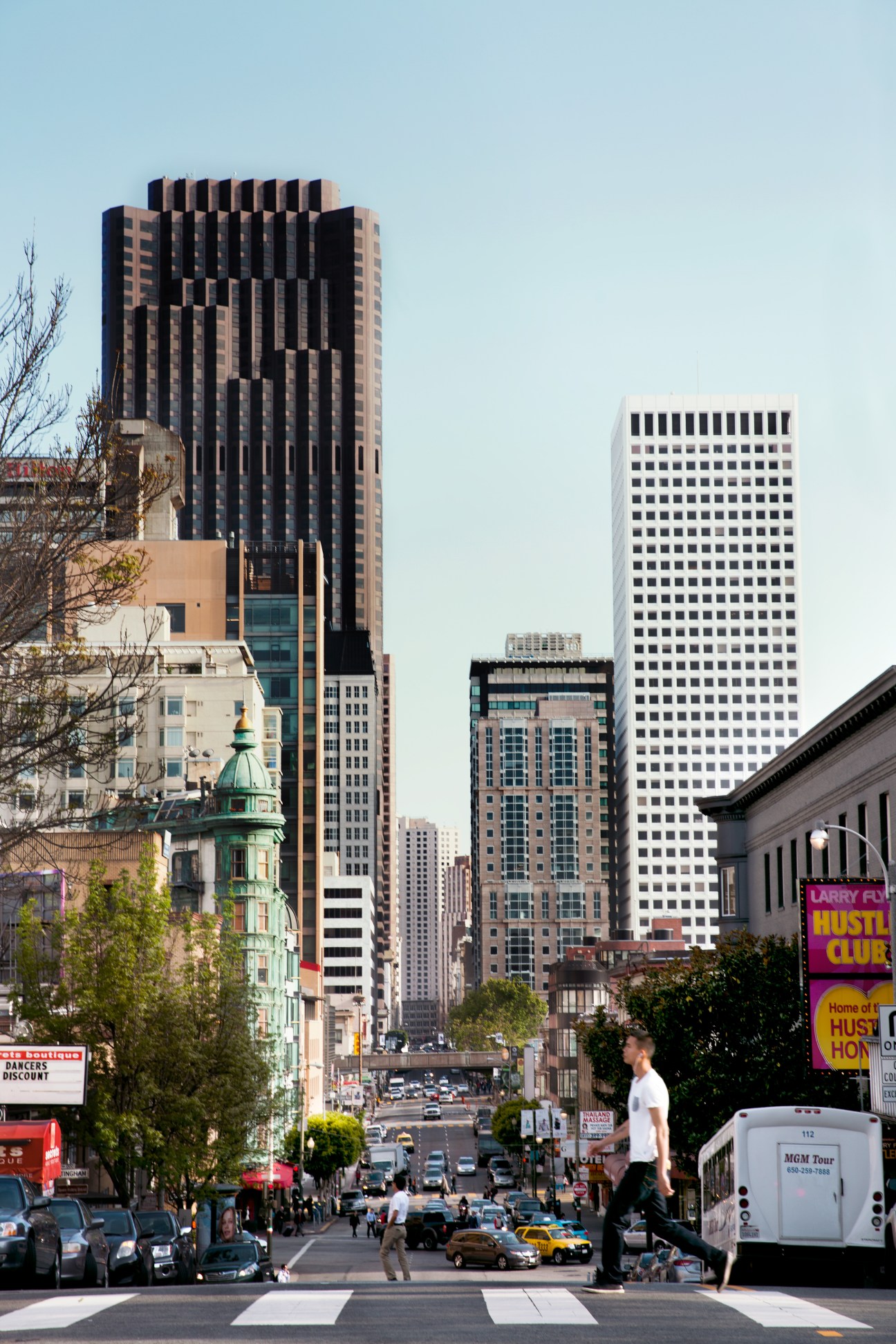 San Francisco street view showing downtown skyscrapers and pedestrians at a crosswalk on Kearny Street.