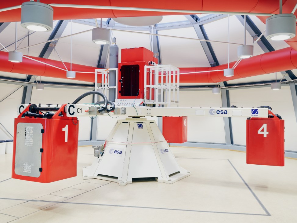 Interior view of Estec's Large Diameter Centrifuge with red and white equipment in a modern facility.