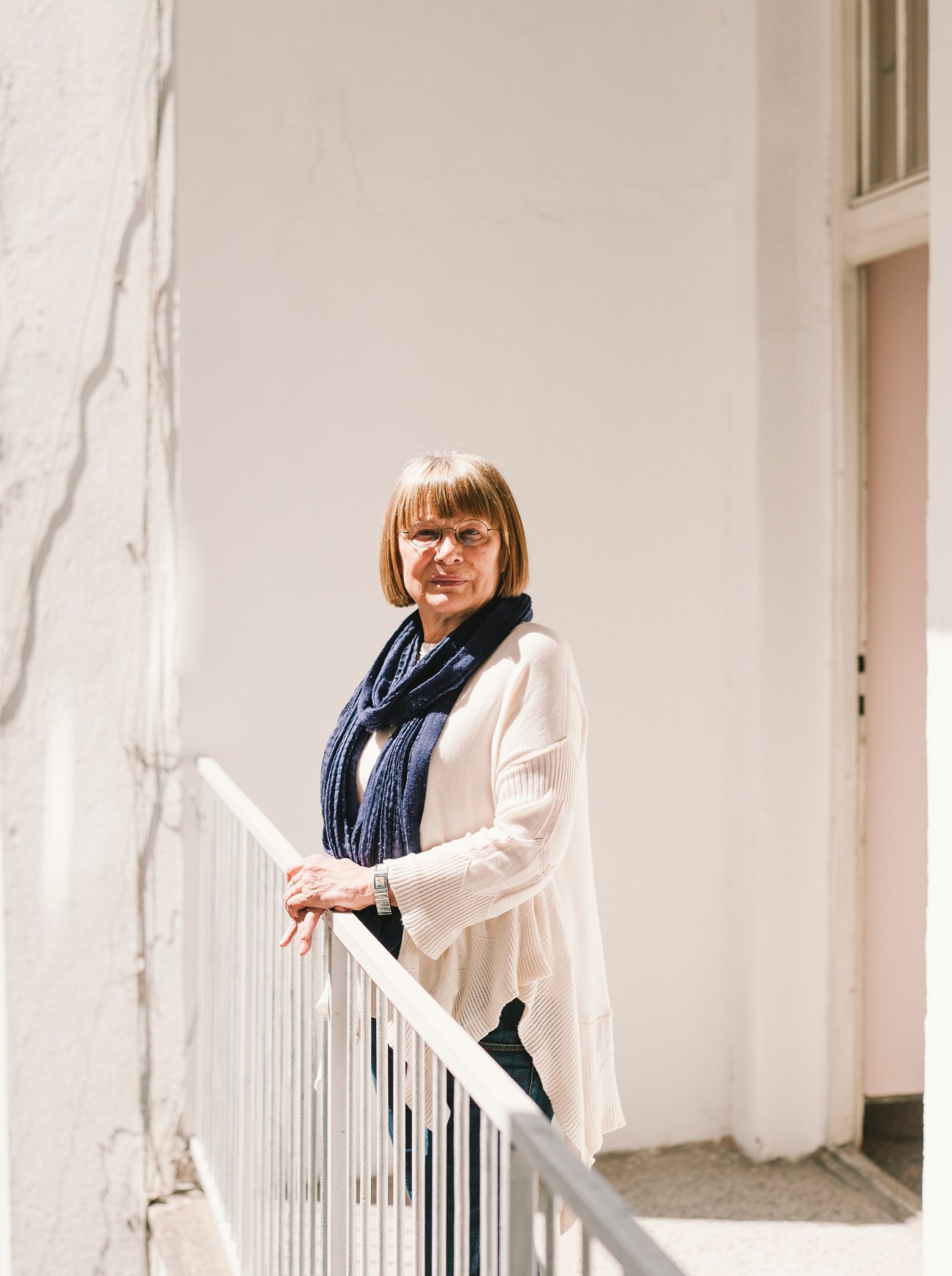 Human-rights campaigner Natasa Kandic standing on a staircase in a white building
