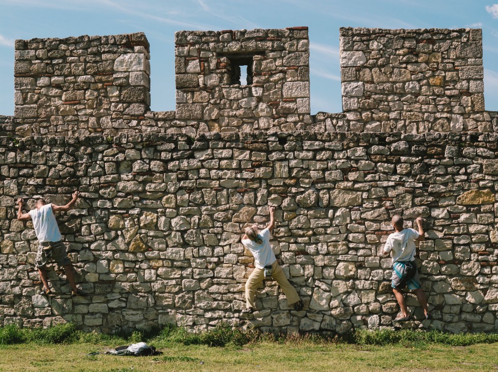 Rock climbers training on ancient stone fortress walls at Kalemegdan Fortress in Belgrade