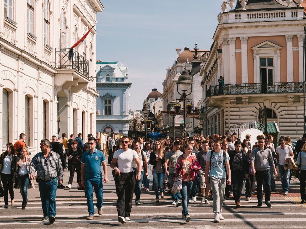 Crowds of pedestrians walking along Knez Mihailova, Belgrade's traffic-free street lined with colorful historic buildings.
