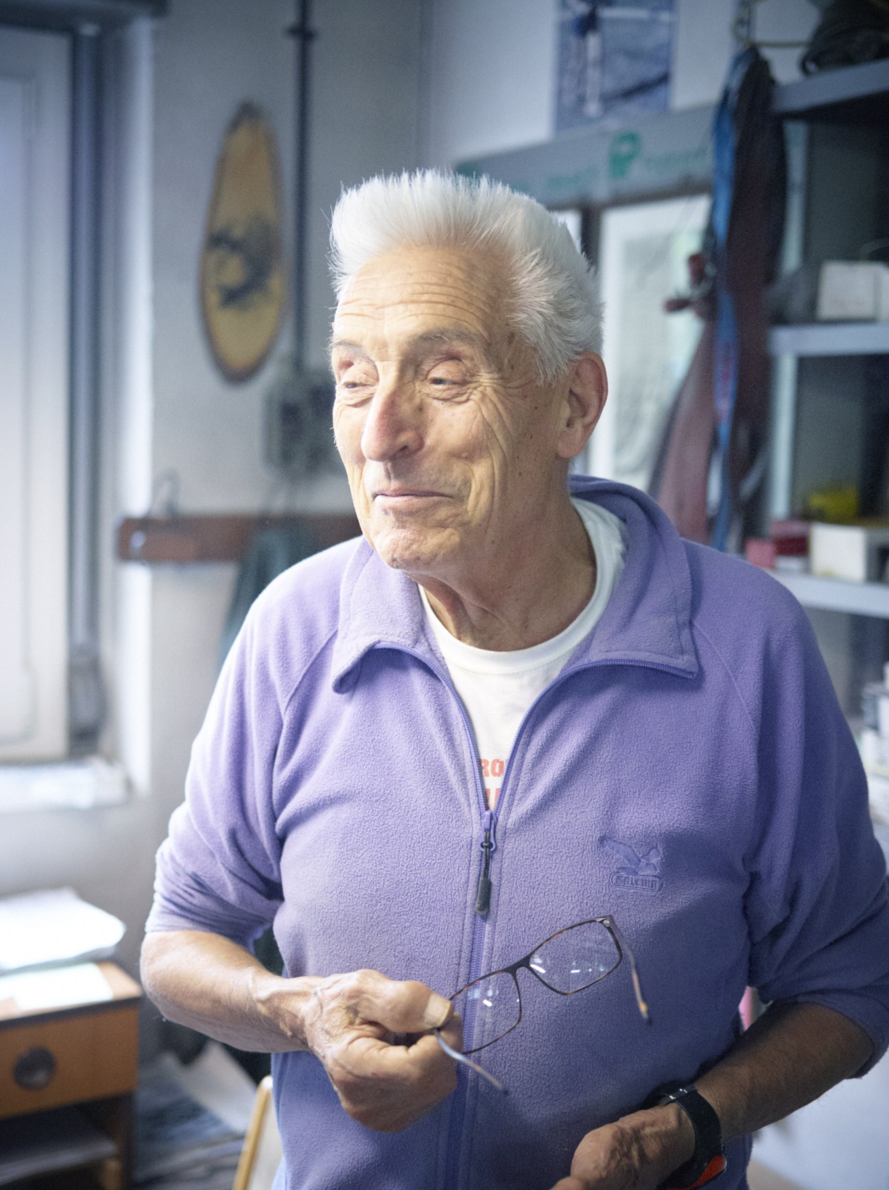 Antonio Frescura, 83-year-old owner of Kador eyewear factory, holds a pair of frames in his workshop.