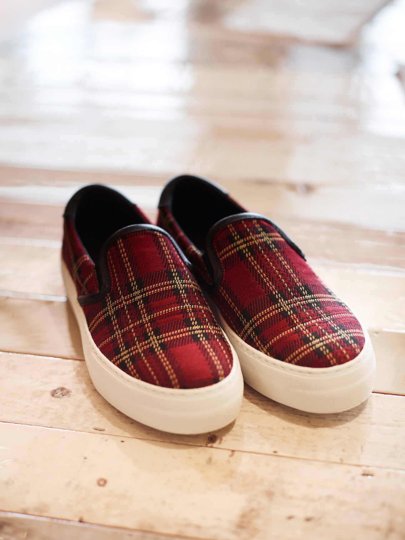 Red and gold tartan slip-on shoes with white rubber sole by Sofie D'Hoore.