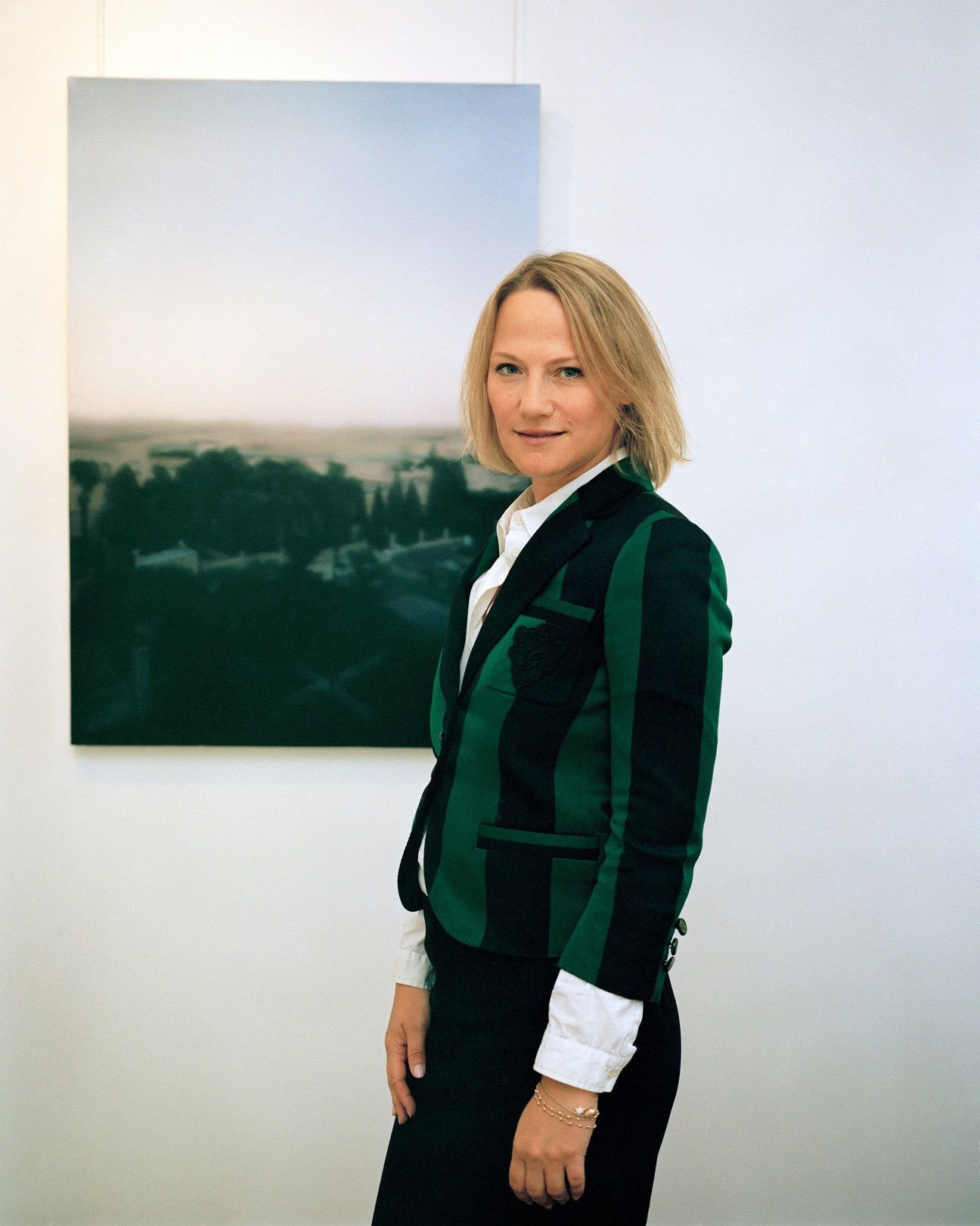 Cheyenne Westphal, chairman of contemporary art at Sotheby's Europe, posing in front of a landscape artwork.