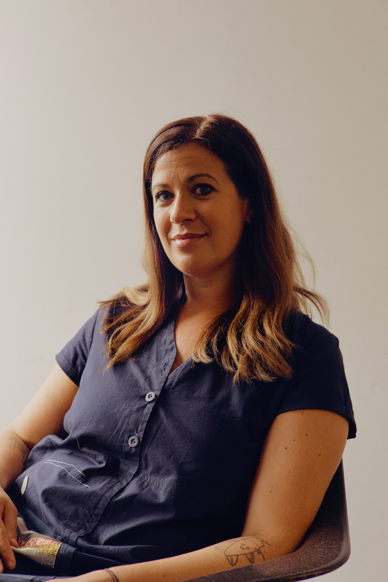 Portrait of Emily Heyward, co-founder and chief strategist of Red Antler branding agency, wearing a dark blue shirt.