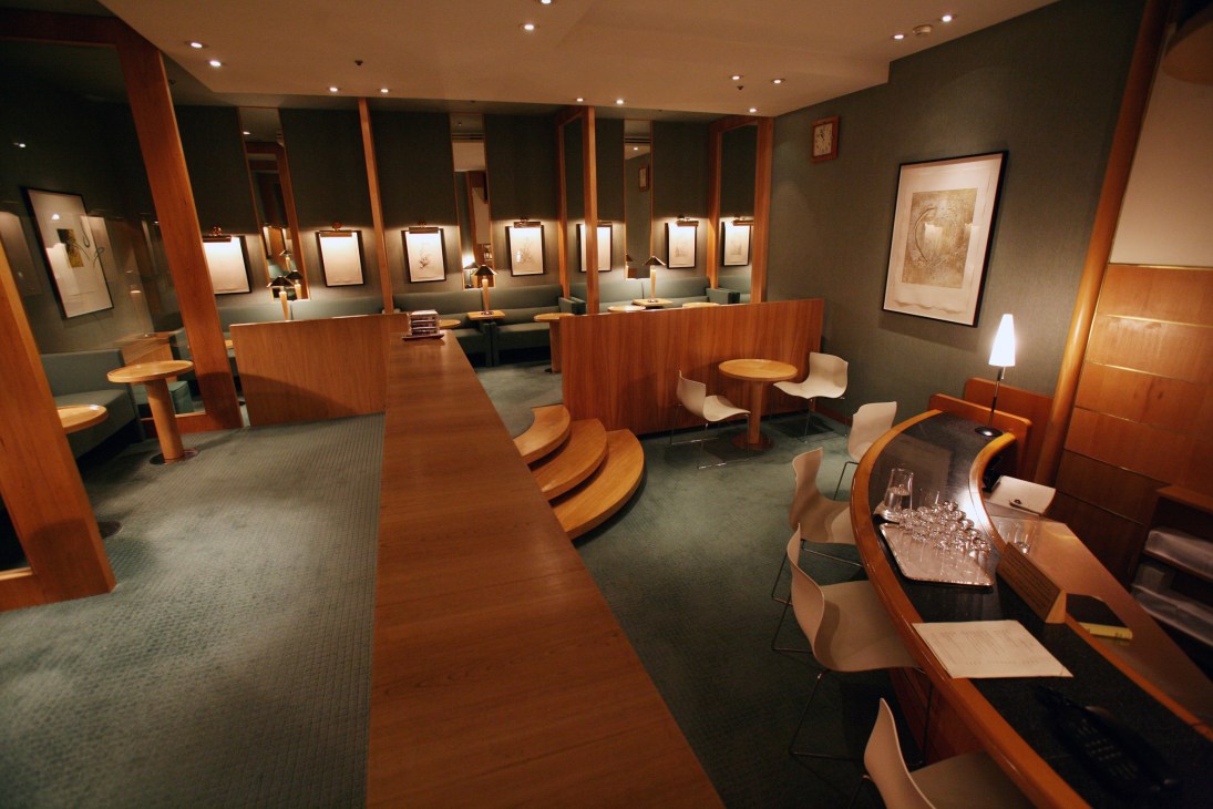 Modern spa interior with wooden partitions, illuminated display cases, and contemporary furnishings at Grand Hyatt Seoul.